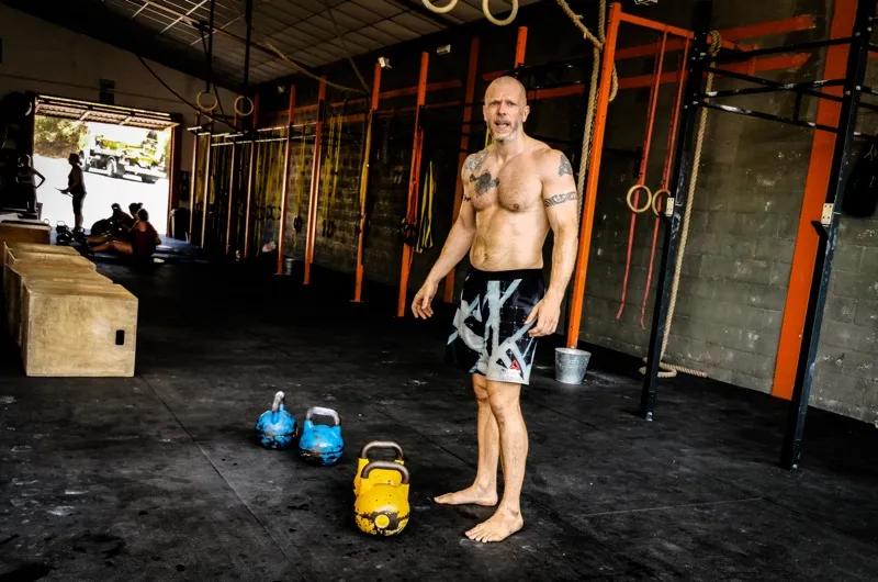 Kettlebell trainer in a CrossFit gym environment